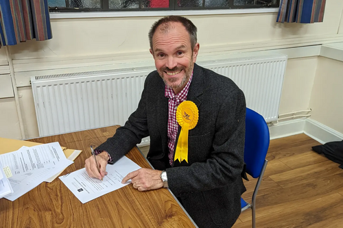 Newly elected councillor Richard Morris signing his declaration of acceptance of office