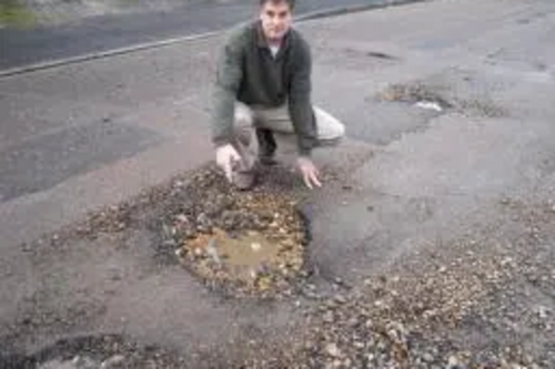 David Goodall inspects just one of the many potholes appearing on Southampton patched road network